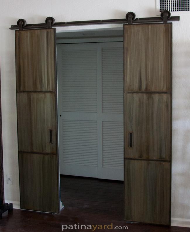 double warehouse style barn door with patina metal