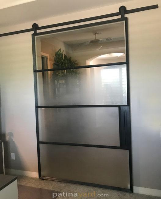 warehouse style sandblasted glass and metal barn door