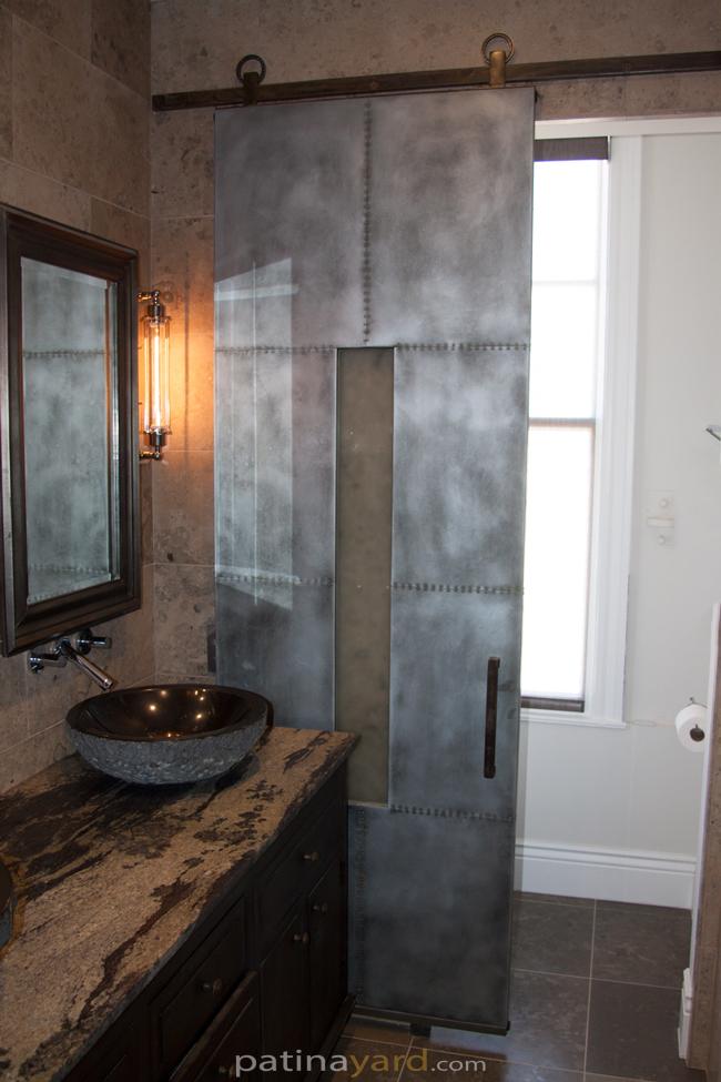 zinc with small rivets and opaque glass bathroom sliding barn door