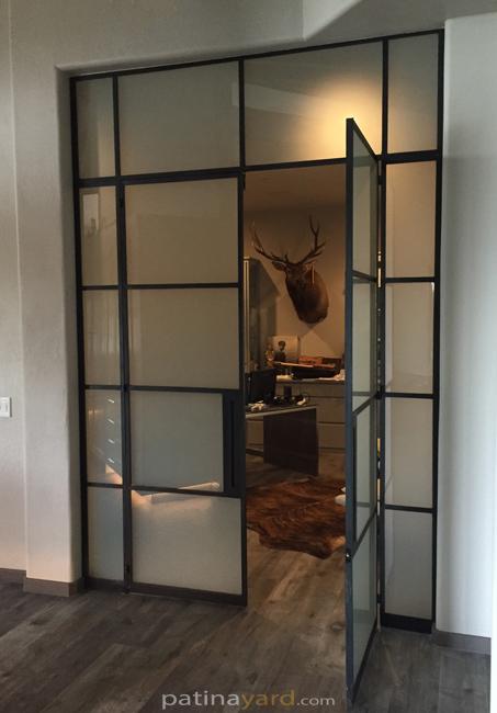 black iron steel doors with satin glass transoms and side lites