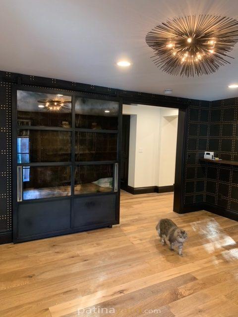 large metal steel barn door with antique mirrors and brass handles