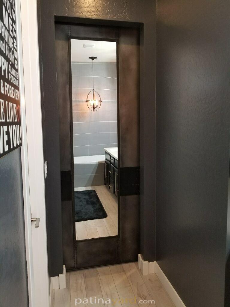 Metal panel framed mirror barn door