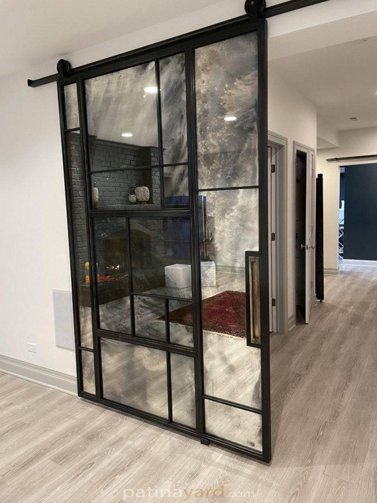 custom antique mirror barn door with random patterns and metal frame