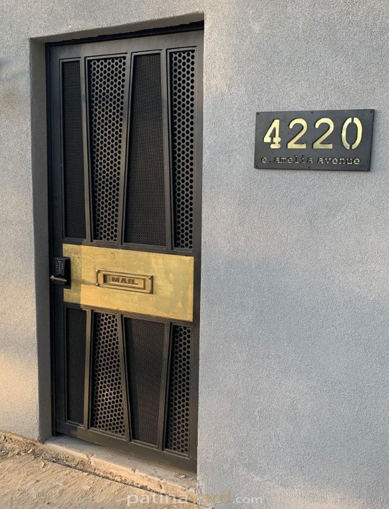 custom metal gate with brass inset