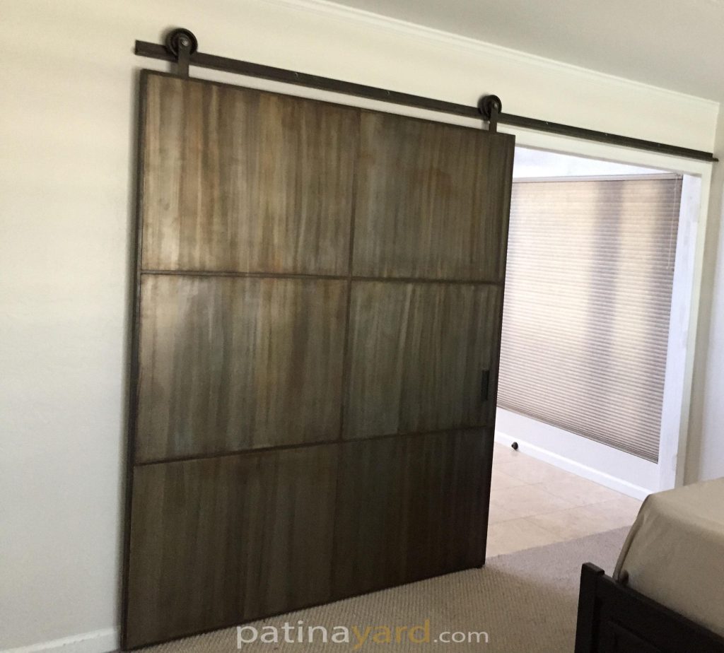 Large metal barn door with custom patina finish