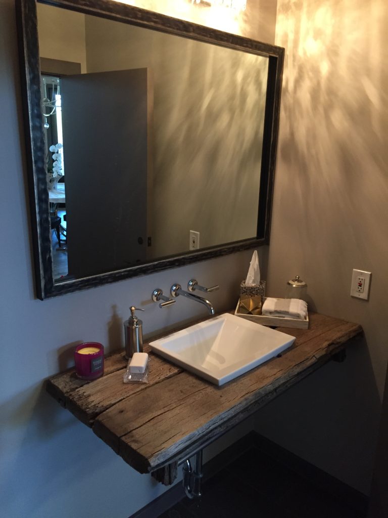 patina metal framed mirror over vanity